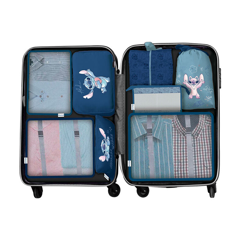 Packed suitcase with summer clothes and passport on wooden backg